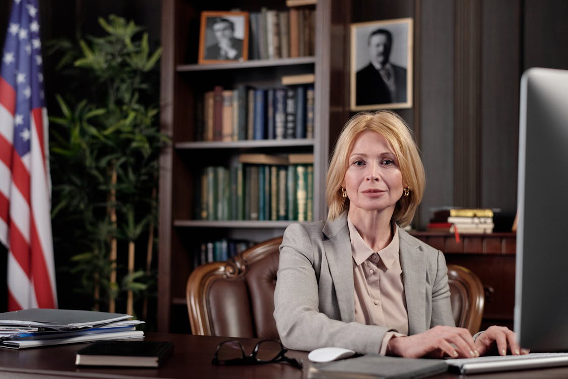 A woman in a suit sitting in an office