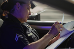 Female traffic police officer writing a ticket on the street in New Jersey