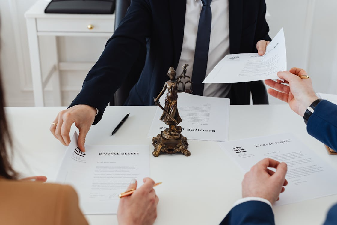 a lawyer handing a couple divorce papers